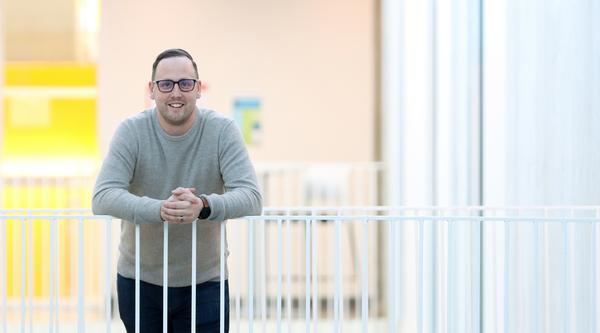 Kyle Duncan leans against a white railing.