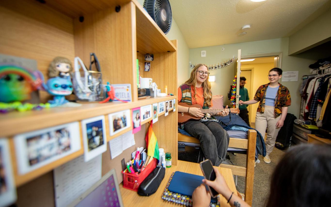 Four students hang out in a dorm