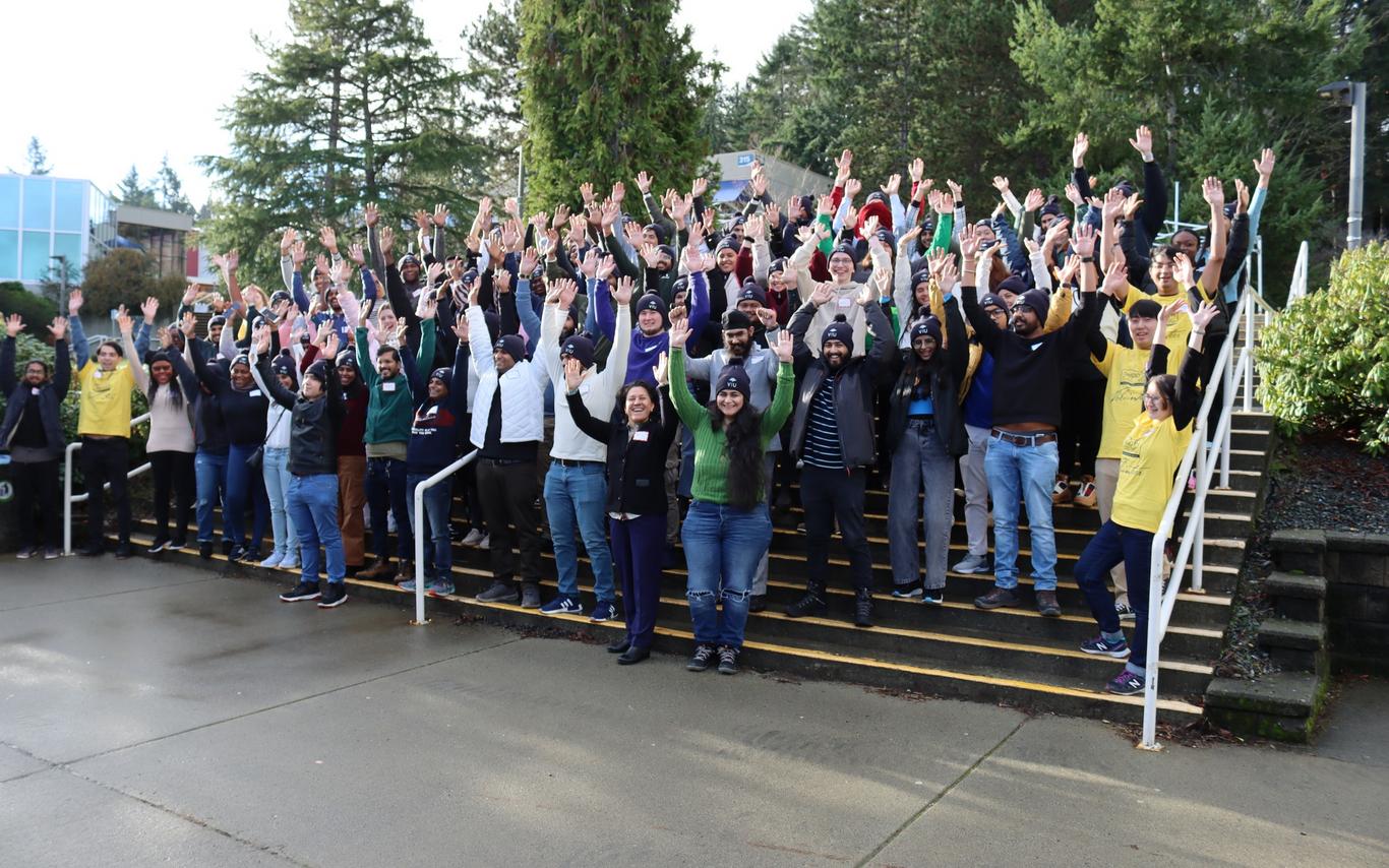 Group photo of people raising their hands in celebration