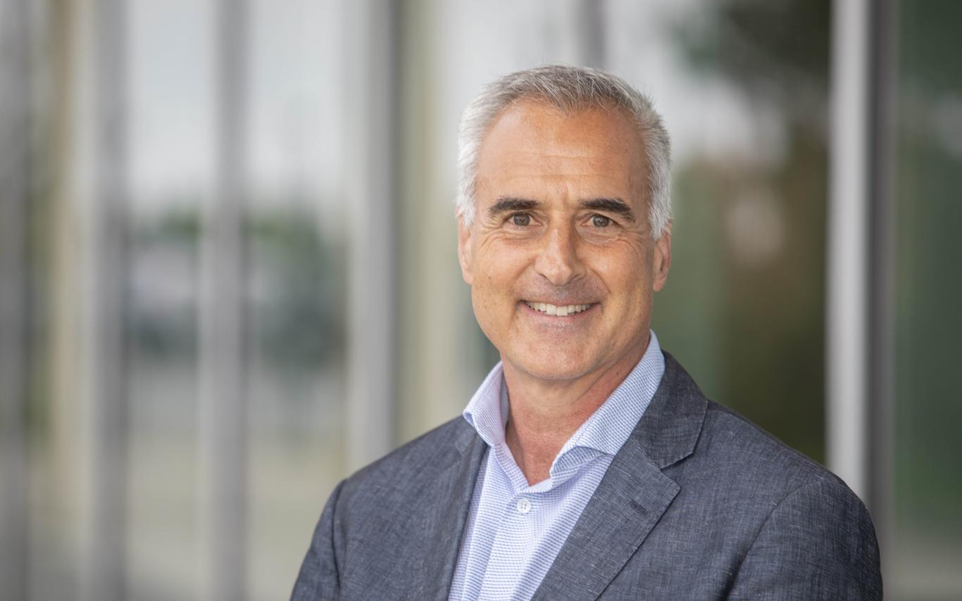 Head shot of Mike Quinn standing in front of the Centre for Health and Science at VIU's Nanaimo campus